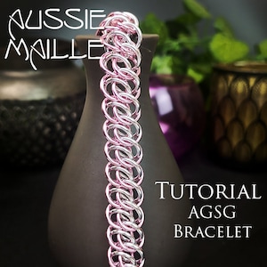 May include: A tutorial for making an AGSG bracelet using pink and silver chainmail. The bracelet is shown on a dark brown vase.