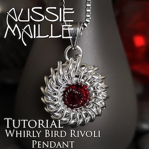 May include: A silver chain necklace with a silver pendant featuring a red jewel in the center. The pendant is made of woven metal rings and is shaped like a flower. The text "TUTORIAL WHIRLY BIRD RIVOLI PENDANT" is below the pendant.