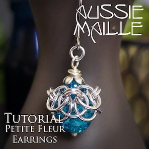 May include: A silver chainmail earring with a teal blue bead center. The earring has a floral design at the top and is labeled "AUSSIE MAILLE" and "TUTORIAL PETITE FLEUR EARRINGS".