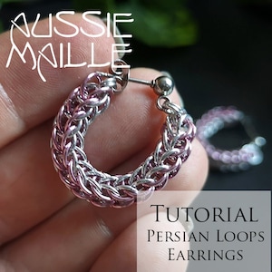 May include: A close-up of a silver and pink chainmail hoop earring. The earring is held in a hand, with a second earring visible in the background. Text in the image reads "AUSSIE MAILLE" and "TUTORIAL PERSIAN LOOPS EARRINGS."