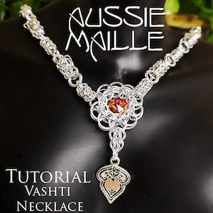May include: A silver chain necklace with a large, intricate pendant featuring a red gemstone. The pendant is shaped like a flower with a smaller, teardrop-shaped pendant hanging from it. The necklace is labelled "Tutorial Vashti Necklace".