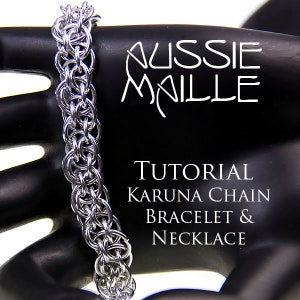 May include: A silver chainmail bracelet and necklace, made with a Karuna chain pattern. The chainmail is displayed on a black mannequin hand. The image includes the text "Aussie Maille" and "Tutorial Karuna Chain Bracelet & Necklace".