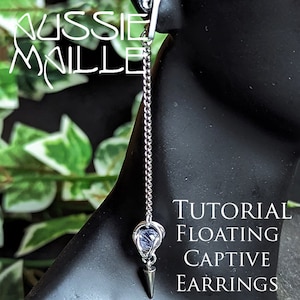 May include: A silver chain earring with a floating captive bead and a pointed end. The earring is on a mannequin's ear. The text "TUTORIAL FLOATING CAPTIVE EARRINGS" is in the lower right corner of the image.