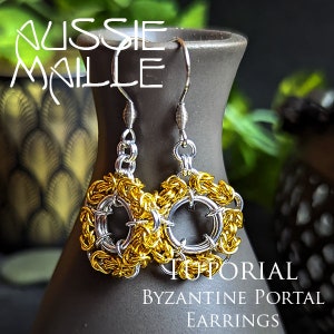 May include: A pair of Byzantine Portal earrings with silver and gold-colored chainmaille. The earrings are displayed on a dark brown vase. The text "AUSSIE MAILLE TUTORIAL" and "Byzantine Portal Earrings" is visible.