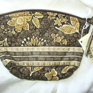 Op de afbeelding: Een bruine en beige gewatteerde toilettas met een bloemenpatroon en een ritssluiting. De tas heeft een klein label met de tekst "Vera Bradley Small Cosmetic 221138".