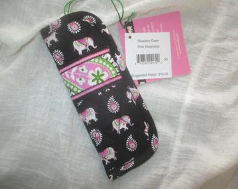 May include: A black quilted fabric readers case featuring a repeating pattern of pink elephants and paisley shapes. A horizontal band across the center displays a pink and green floral design. A white tag attached reads Readers Case Pink Elephants.