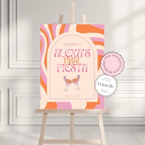 May include: A pink and orange welcome sign with the text "Welcome to Alexa's Final Fiesta" and the date "August 2-4 2025". The sign features a graphic of two martini glasses with cherries and a pink and orange swirl pattern.