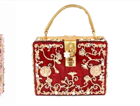Red  acrylic finish handbag  embellished with rhinestones  and Baroque and Victorian  style designs