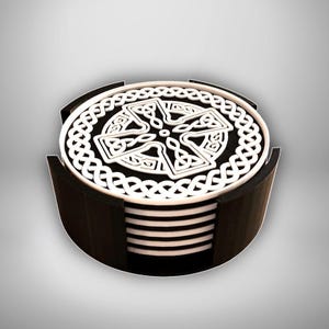 May include: A set of six black and white coasters with a Celtic knot design. The coasters are stacked in a black holder.