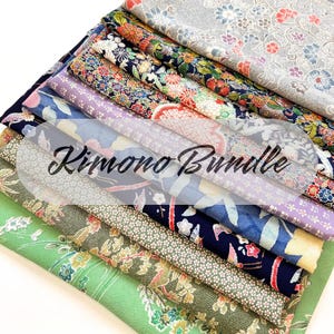 May include: A stack of colorful kimono fabric bundles. The fabrics feature floral and geometric patterns in shades of blue, green, purple, and red. The text "Kimono Bundle" is overlaid on the image.