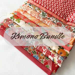 May include: A bundle of 10 different fabrics featuring traditional Japanese kimono patterns. The fabrics are a mix of red, white, and gold colors with floral and geometric designs.  The fabrics are arranged in a stack, with the top fabric folded over the others.  The text "Kimono Bundle" is written in black on a white background.