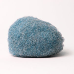 May include: A large, round, blue ball of wool yarn. The yarn is soft and fluffy, and it is perfect for knitting or crocheting.