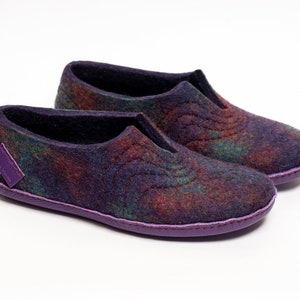 May include: A pair of purple and black wool slippers with a patterned design. The slippers have a purple trim around the edges.