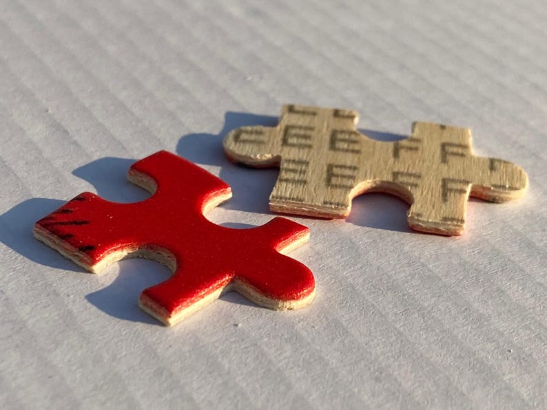 May include: Two puzzle pieces, one red and one beige, fit together to complete a larger image. The red piece has a smooth surface, while the beige piece has a textured surface.