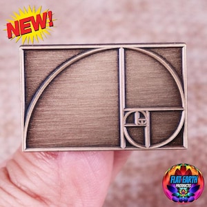 May include: A gold-toned metal pin featuring a geometric design of a spiral, known as the Golden Spiral, which is based on the Fibonacci sequence. The pin is square in shape with rounded corners.