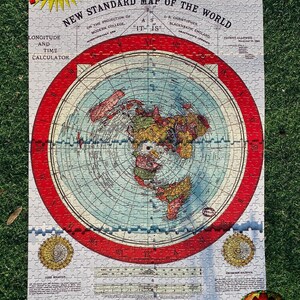 May include: A vintage jigsaw puzzle featuring a flat earth map with a red border. The puzzle is titled "Gleason's New Standard Map of the World" and includes a longitude and time calculator. The puzzle is made by the Buffalo Electro-Chemical Co. in Buffalo, NY.