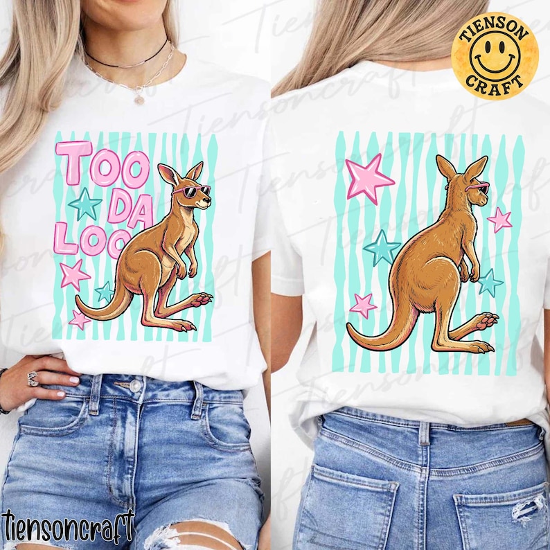 May include: White t-shirt with a cartoon kangaroo wearing sunglasses. The front design features the text "TOO DA LOO" in pink, with stars and a blue striped background. The back of the shirt has a similar kangaroo design with stars.
