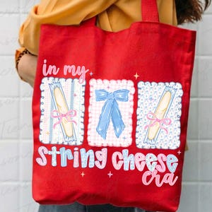 May include: Red tote bag with the text "in my string cheese era." The bag features three decorative frames with a bow and string cheese illustrations. The bag has red handles and is held by a person.