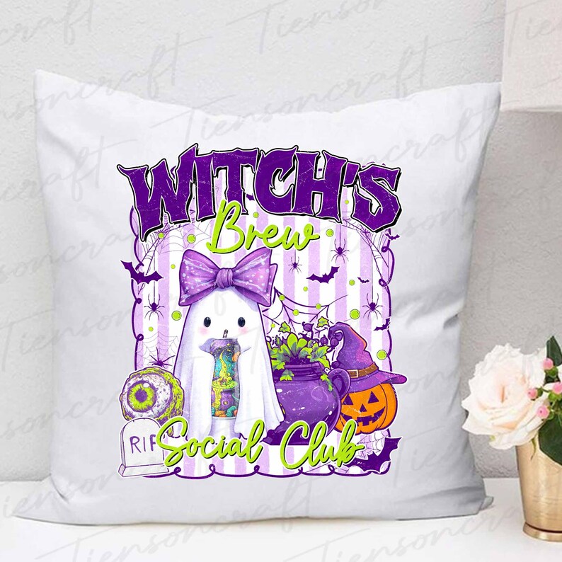 May include: White square pillow with a Halloween-themed design. The design features a ghost with a purple bow, a witch's cauldron, a jack-o'-lantern, and the text "Witch's Brew Social Club" in purple and green.