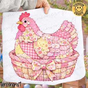 May include: A pink and floral patchwork hen sitting in a woven basket with a bow. The hen has a red comb and beak. The basket and hen are made of various pink and yellow floral and gingham fabrics.
