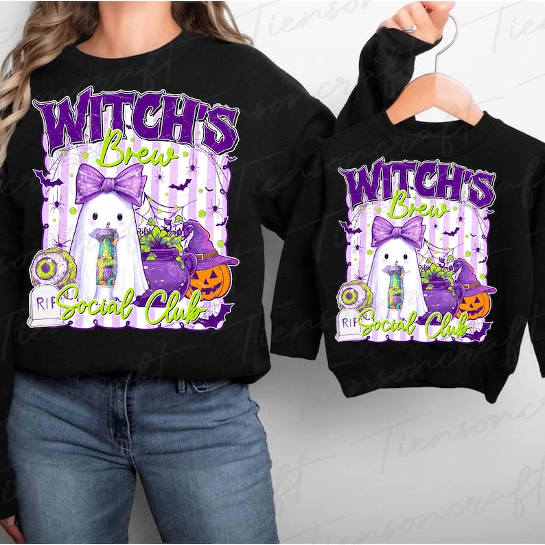 May include: Black sweatshirts with a Halloween-themed graphic. The design features a ghost with a purple bow, a cauldron, a jack-o'-lantern, and the text "Witch's Brew Social Club". The design is in purple, green, and white.