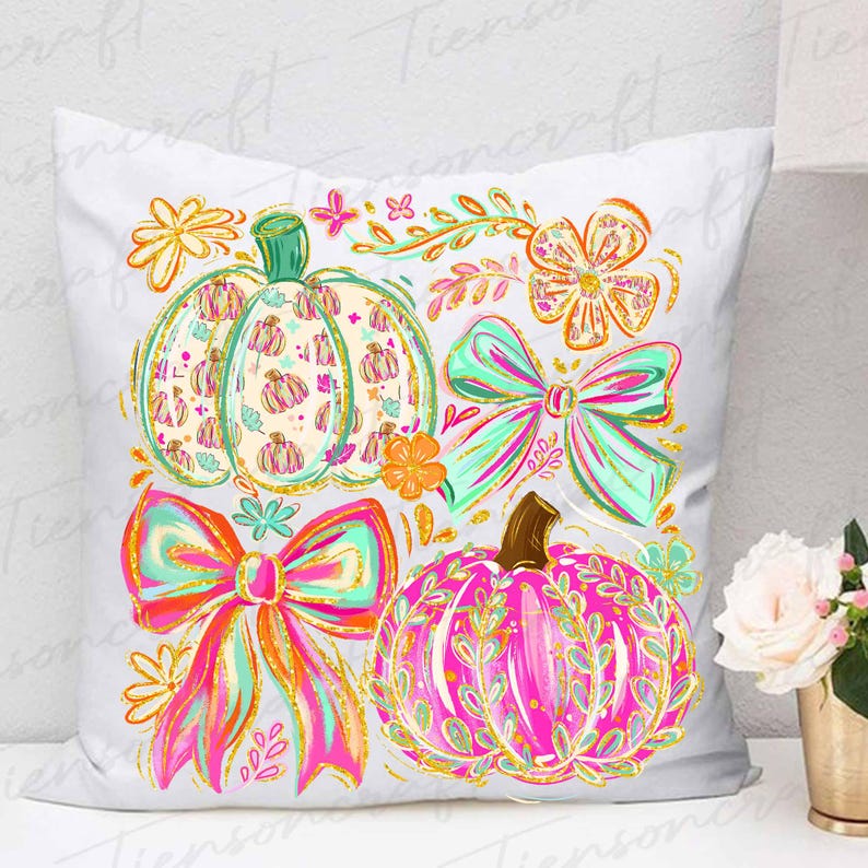 May include: White decorative pillow featuring colorful pumpkins and bows. The pumpkins are in shades of pink, orange, and green, with floral and leaf patterns. The bows are in bright pink, orange, and teal with gold glitter accents. Floral accents complete the design.