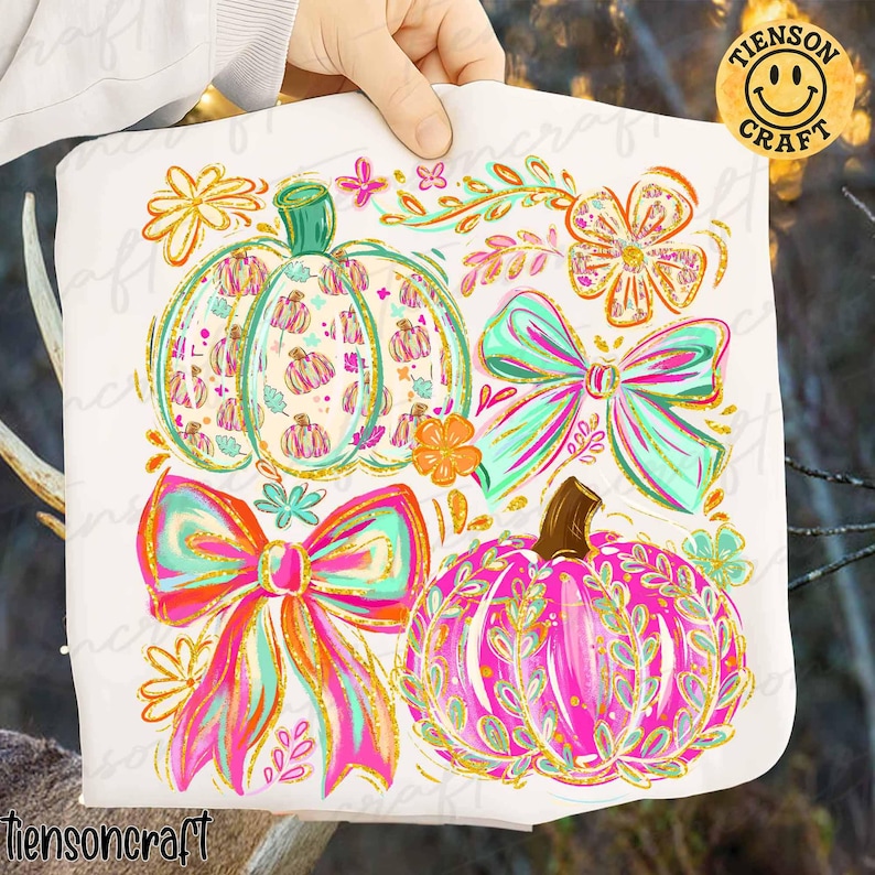 May include: A white fabric featuring colorful pumpkin and bow designs. The pumpkins are decorated with patterns and leaves, and the bows have bright pink, orange, and teal accents. The text "tiensoncraft" is visible at the bottom.
