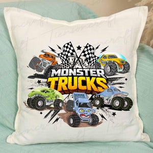 May include: A white square cushion with a vibrant graphic of monster trucks. The design showcases five cartoon monster trucks in orange, yellow, green, blue, and light blue, with the words "MONSTER TRUCKS" in a yellow and orange font. Checkered flags are also included.