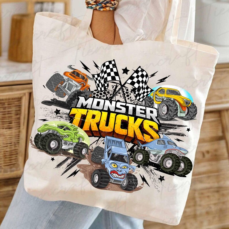 May include: A cream tote bag with a vibrant monster truck design. The graphic showcases several monster trucks in orange, green, yellow, blue, and light blue, accompanied by checkered flags and the text "MONSTER TRUCKS" in yellow and orange.