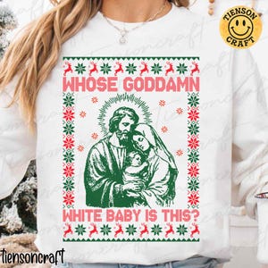 May include: White sweatshirt with a Christmas-themed design. The graphic features a green and red border with reindeer and snowflakes. The central image depicts a religious scene with the text "WHOSE GODDAMN WHITE BABY IS THIS?"