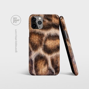 May include: A brown and black leopard print phone case with a camera cutout. The case is made of a durable material and is designed to protect your phone from scratches and bumps.