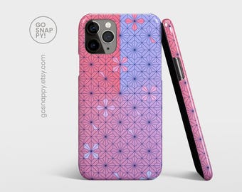 May include: A pink and purple phone case with a geometric pattern. The case has a raised camera bump and a black side.