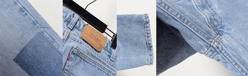 May include: Light blue denim jeans featuring a tan leather patch on the back waistband, a small red fabric tag on the back pocket, reinforced stitching along the seams, and a straight-leg hem with visible fading and distressed texture details.