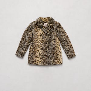 May include: A double-breasted coat with a leopard print pattern. The coat features a notched collar, long sleeves, and a button closure. The coat's colors include tan, black, and brown.
