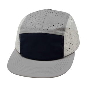 May include: A gray and navy blue baseball cap with a perforated crown and a gray brim. The cap has a navy blue panel on the front.