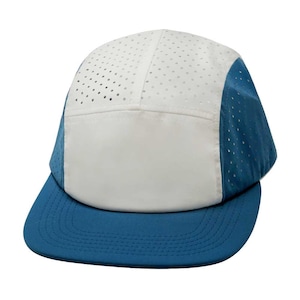 May include: A white and blue baseball cap with a mesh panel and a blue brim. The cap has a white crown with a blue panel on the side.