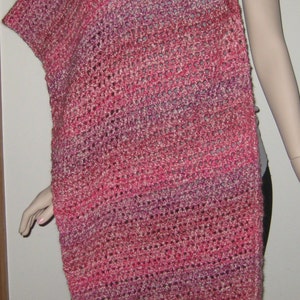 May include: A pink, purple, and white crocheted shawl with a lacy pattern.