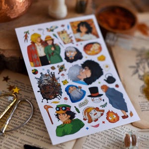 May include: A sheet of colorful stickers featuring illustrations of characters from a fantasy animated film. The stickers depict various characters in different poses and scenes, with vibrant colors and detailed artwork. The stickers are on a white background.