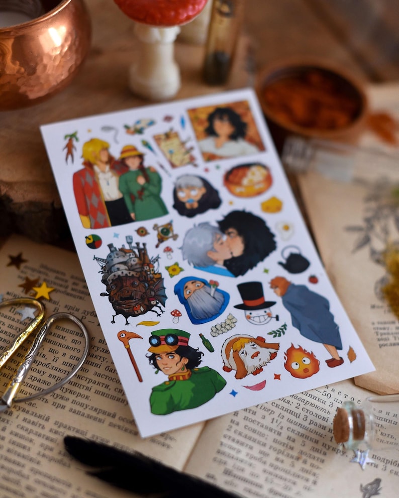 May include: A sheet of colorful stickers featuring illustrations of characters from a fantasy animated film. The stickers depict various characters in different poses and scenes, with vibrant colors and detailed artwork. The stickers are on a white background.