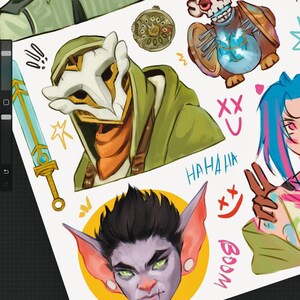 May include: A digital illustration sheet featuring various character designs, including a figure in a green hood and white mask, a creature with a glowing blue orb, a character with spiky dark hair and large ears, and a sword, with text reading HAHAHA and BOOM.