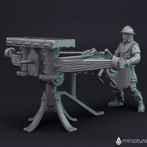 May include: A gray 3D printed miniature of a medieval siege weapon, a trebuchet, with a figure of a soldier winding the arm. The trebuchet has a wooden arm and a spiked projectile.