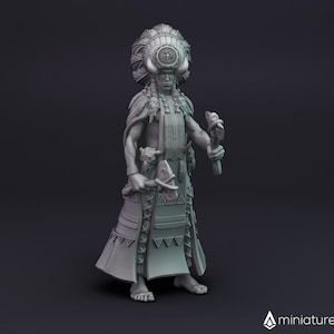 May include: A grey 3D printed miniature of a person wearing a headdress with feathers and a detailed patterned skirt. The figure is holding a staff with a bird on top.