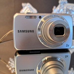 Appareil photo numérique Samsung PL 20 - 14,2 MP, état neuf, argent avec carte mémoire de 4 Go, parfait pour un cadeau, un voyage et un usage quotidien