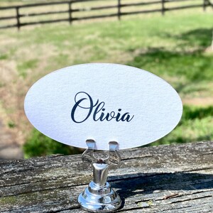 May include: A set of three ceramic mugs with a speckled, matte finish. The mugs are in shades of cream, light gray, and dark gray. Each mug has a simple, minimalist design, perfect for coffee or tea.