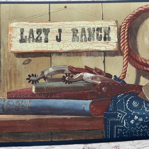 May include: Western-themed wall border featuring a horseshoe, cowboy hat, rope, and spurs. A sign that reads "Lazy J Ranch" is also visible. The color palette includes shades of brown, red, and blue.