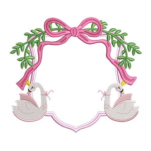 May include: A pink and green embroidered design featuring two white swans with crowns, a pink bow, and a blank shield-shaped frame.