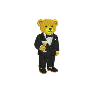 May include: Embroidered image of a teddy bear wearing a black tuxedo with a bow tie and holding a cocktail glass. The bear has yellow fur, a black nose, and is wearing black shoes. The image is on a white background.