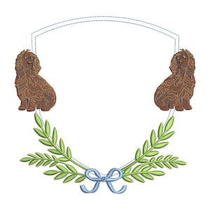May include: A brown dog with a blue bow sits on either side of a white shield with a green leafy wreath around the bottom.
