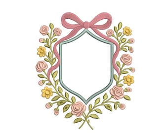 May include: An embroidered floral crest design featuring a light blue shield shape, surrounded by pink roses, yellow flowers, and green leaves. A pink ribbon bow adorns the top. The design is on a white background.