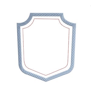 May include: A shield-shaped design with a white interior and a light blue and white striped border. The interior is outlined with a thin red line. The shield has a decorative, curved top and bottom.